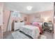 Comfortable bedroom with a rainbow-themed bedding, plush rug and natural light at 7034 S Cherry St, Centennial, CO 80122