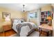 Cozy bedroom features a chandelier, hardwood floors, and light-filled windows at 7034 S Cherry St, Centennial, CO 80122