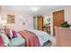 Charming pink bedroom with rainbow accents, plush bed, and dedicated vanity space at 7034 S Cherry St, Centennial, CO 80122