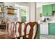 Cozy dining area with a view into the kitchen and decorative shelving at 7034 S Cherry St, Centennial, CO 80122