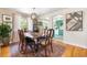 Charming dining room with hardwood floors, a stylish rug, and an open view to the kitchen at 7034 S Cherry St, Centennial, CO 80122