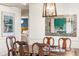 Formal dining area with wood table, chairs, and view of the modern kitchen at 7034 S Cherry St, Centennial, CO 80122
