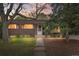 Charming brick home with manicured lawn, mature trees and a welcoming front porch at 7034 S Cherry St, Centennial, CO 80122