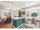 Open kitchen connected to dining area, featuring green cabinets and a breakfast nook at 7034 S Cherry St, Centennial, CO 80122