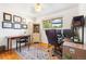 Home office setup with hardwood floors, a large desk, and natural light at 7034 S Cherry St, Centennial, CO 80122