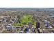 Aerial view of lush green park surrounded by city neighborhoods and residential buildings at 1085 N Lafayette St # 702, Denver, CO 80218