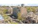Aerial view of multi-story condo and apartments surrounded by mature trees at 1085 N Lafayette St # 702, Denver, CO 80218