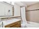 Bathroom featuring a sleek vanity, modern fixtures, and tiled bathtub, offering a clean and contemporary space at 1085 N Lafayette St # 702, Denver, CO 80218