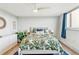 Bright bedroom with a floral comforter, stylish lamps, and ample natural light, creating a peaceful atmosphere at 1085 N Lafayette St # 702, Denver, CO 80218