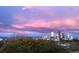 Stunning city view with colorful sunset and silhouetted skyline, above lush trees at 1085 N Lafayette St # 702, Denver, CO 80218