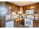 Updated kitchen featuring modern appliances, granite countertops, and stylish tile backsplash at 1085 N Lafayette St # 702, Denver, CO 80218