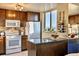 Modern kitchen featuring stainless appliances, wood cabinetry, and wine rack at 1085 N Lafayette St # 702, Denver, CO 80218