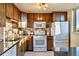 Well-equipped kitchen with wooden cabinets, stainless steel appliances, and natural light at 1085 N Lafayette St # 702, Denver, CO 80218