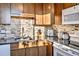 Sunlit kitchen features granite countertops, stainless steel appliances, and mosaic tile backsplash at 1085 N Lafayette St # 702, Denver, CO 80218