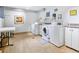 Clean laundry room featuring multiple white washers and dryers, plus a folding table at 1085 N Lafayette St # 702, Denver, CO 80218