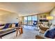 Bright living room with large windows, balcony, and comfortable seating at 1085 N Lafayette St # 702, Denver, CO 80218