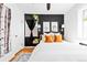 Stylish bedroom with white bedding, black accent wall, and hanging plants at 1160 Birch St # 22, Denver, CO 80220