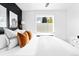 Bright bedroom with white bedding, black accent wall, and modern decor at 1160 Birch St # 22, Denver, CO 80220