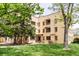 Multi-Gathering building with a well-maintained lawn, mature trees, and brick facade with classic architectural details at 1160 Birch St # 22, Denver, CO 80220