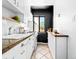 Bright kitchen features white cabinets, granite countertops, and black accent wall at 1160 Birch St # 22, Denver, CO 80220