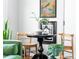 Charming seating area featuring a black round table, wood chairs, and stylish decor at 1160 Birch St # 22, Denver, CO 80220