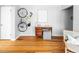 Spacious living room with desk, hardwood floors, and wall mounted bike rack at 1160 Birch St # 22, Denver, CO 80220