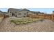 Wide view of the backyard showing gravel, grass, fence and houses nearby at 3492 N Buchanan Way, Aurora, CO 80019