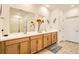 Bathroom boasting double sinks, white quartz countertop, decorative flowers, and a shower at 3492 N Buchanan Way, Aurora, CO 80019