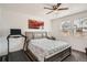 Comfortable bedroom featuring a ceiling fan, an art piece, and natural light from the windows at 3492 N Buchanan Way, Aurora, CO 80019