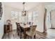 Inviting dining space with modern lighting, a decorative rug, and sliding glass door access at 3492 N Buchanan Way, Aurora, CO 80019