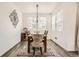 Cozy dining area with a rustic table, stylish chairs, decorative wall art, and ample sunlight at 3492 N Buchanan Way, Aurora, CO 80019