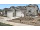 Charming townhome with stone accents, attached garages, and landscaped front yard at 3492 N Buchanan Way, Aurora, CO 80019