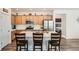 Well-lit kitchen features stainless steel appliances, ample cabinets, and an island with seating at 3492 N Buchanan Way, Aurora, CO 80019