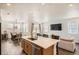 Open-concept kitchen features an island, stainless steel appliances, and easy access to dining and living areas at 3492 N Buchanan Way, Aurora, CO 80019
