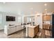 Open-concept kitchen and living area with a large island and modern appliances at 3492 N Buchanan Way, Aurora, CO 80019