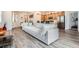 Open-concept living room and kitchen with modern furniture and stainless steel appliances at 3492 N Buchanan Way, Aurora, CO 80019