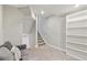 Finished basement featuring neutral paint, plush carpet, stairs, and built-in shelving at 684 Poppy Pl, Highlands Ranch, CO 80129