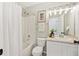 A bathroom features white tile in the shower and a white vanity at 684 Poppy Pl, Highlands Ranch, CO 80129