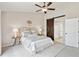 Bedroom featuring a sliding barn door to a bathroom, a ceiling fan, and a rattan headboard at 684 Poppy Pl, Highlands Ranch, CO 80129