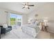Bedroom featuring a sliding glass door to a deck, a ceiling fan, and a rattan headboard at 684 Poppy Pl, Highlands Ranch, CO 80129