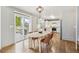 Sunlit dining area opens to a deck via sliding doors, adjacent to a modern kitchen with white cabinets and countertops at 684 Poppy Pl, Highlands Ranch, CO 80129