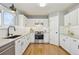 Bright kitchen featuring white cabinets, stainless steel appliances, granite countertops, and subway tile backsplash at 684 Poppy Pl, Highlands Ranch, CO 80129