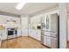 Well-lit kitchen featuring stainless steel appliances, white cabinets, granite countertops, and a subway tile backsplash at 684 Poppy Pl, Highlands Ranch, CO 80129