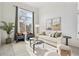 Cozy living room features neutral color scheme, large window, and comfortable seating arrangement at 684 Poppy Pl, Highlands Ranch, CO 80129