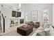 Bright living room featuring a fireplace, neutral furnishings, and ample natural light at 684 Poppy Pl, Highlands Ranch, CO 80129