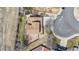 Aerial view of a house with a brown roof, green lawns, driveway, and a trampoline at 10885 Longs Peak Ln, Parker, CO 80138