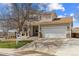 Charming two-story home features a two-car garage and manicured front yard at 10885 Longs Peak Ln, Parker, CO 80138