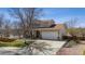 Charming two-story home featuring a well-maintained lawn and a two-car garage at 10885 Longs Peak Ln, Parker, CO 80138
