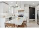 Bright kitchen featuring white cabinetry, stainless steel appliances, and island seating at 10885 Longs Peak Ln, Parker, CO 80138