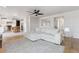 Open-concept living room features a large sectional and seamless access to the kitchen and dining at 10885 Longs Peak Ln, Parker, CO 80138